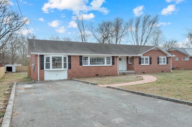 single story home with brick siding, fence, driveway, crawl space, and roof with shingles