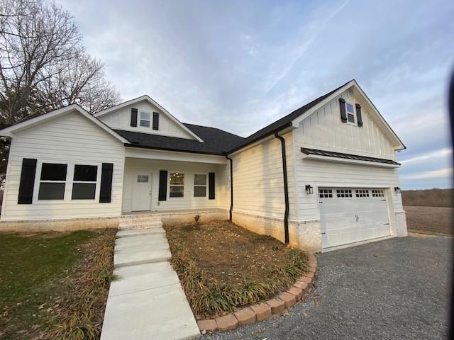 view of front of house featuring a garage, driveway, and board and batten siding