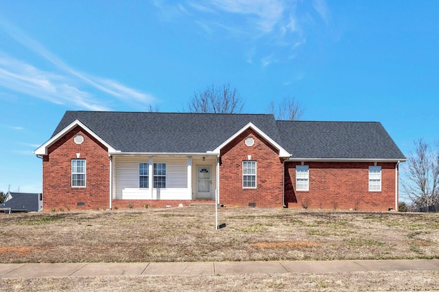 ranch-style house featuring crawl space, a front lawn, brick siding, and roof with shingles