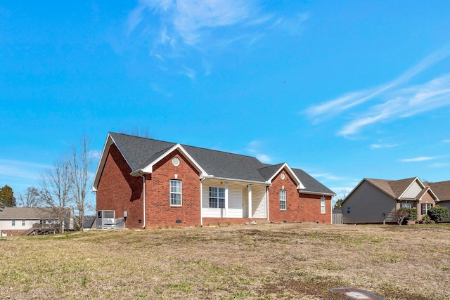 view of front of property with a front lawn, central AC unit, brick siding, and crawl space