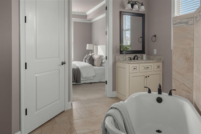 ensuite bathroom featuring plenty of natural light, a soaking tub, crown molding, and vanity