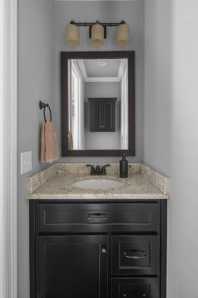 bathroom with crown molding and vanity