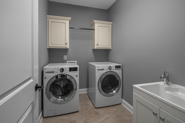 laundry room with washer and clothes dryer, a sink, cabinet space, and baseboards