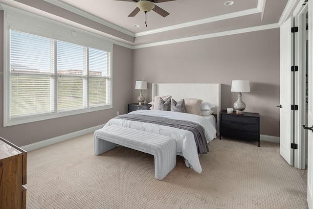 bedroom with ornamental molding, a tray ceiling, and baseboards