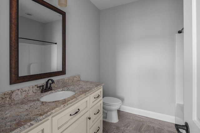 bathroom with  shower combination, toilet, vanity, and baseboards