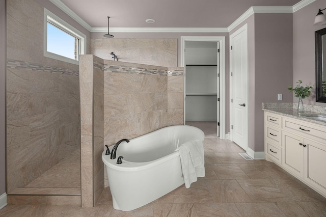 bathroom with ornamental molding, walk in shower, a freestanding tub, and vanity