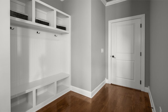 mudroom with dark wood finished floors and baseboards