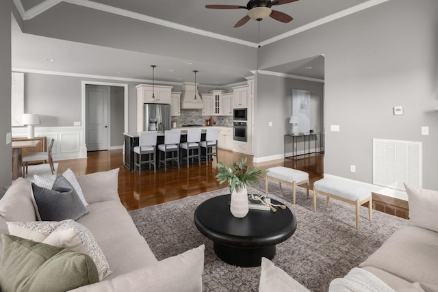 living area with recessed lighting, visible vents, a ceiling fan, ornamental molding, and dark wood finished floors