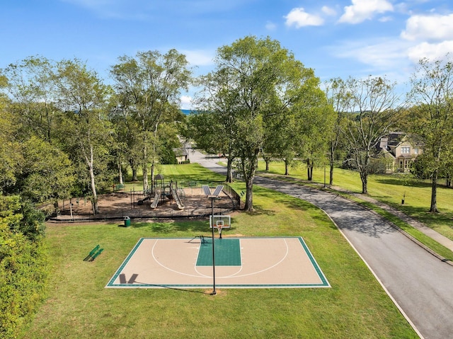 view of basketball court with community basketball court, playground community, and a yard