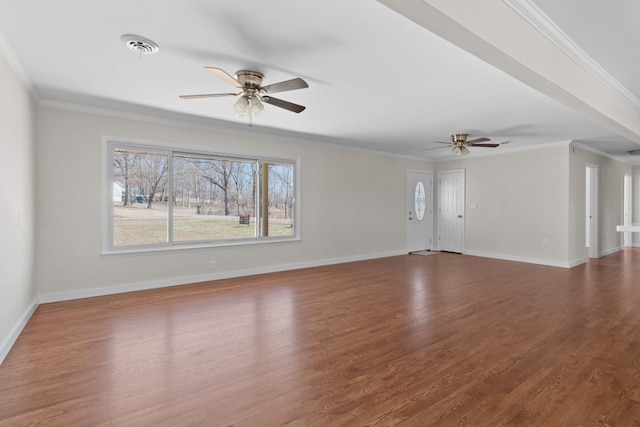 unfurnished living room featuring crown molding, baseboards, and wood finished floors