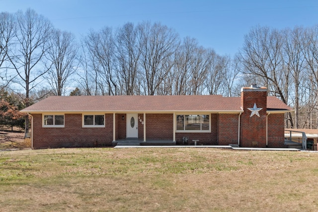 ranch-style house with brick siding, a chimney, a front lawn, and roof with shingles