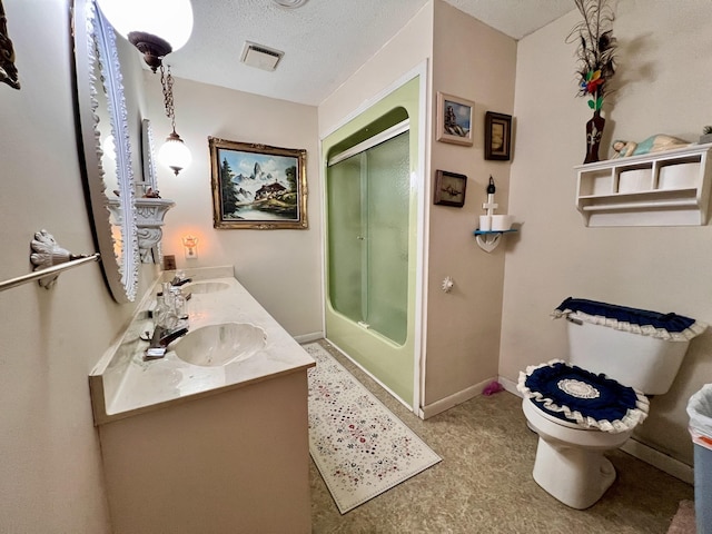 bathroom with toilet, a textured ceiling, baseboards, and a sink