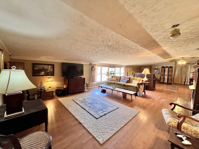 living area with a textured ceiling and wood finished floors