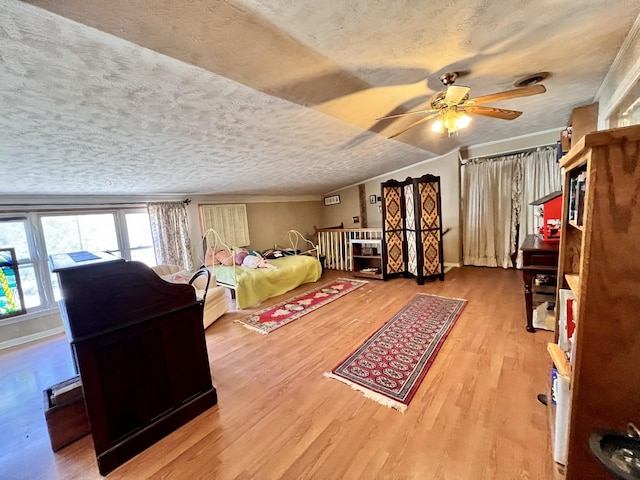 bedroom featuring a textured ceiling, ceiling fan, ornamental molding, and wood finished floors