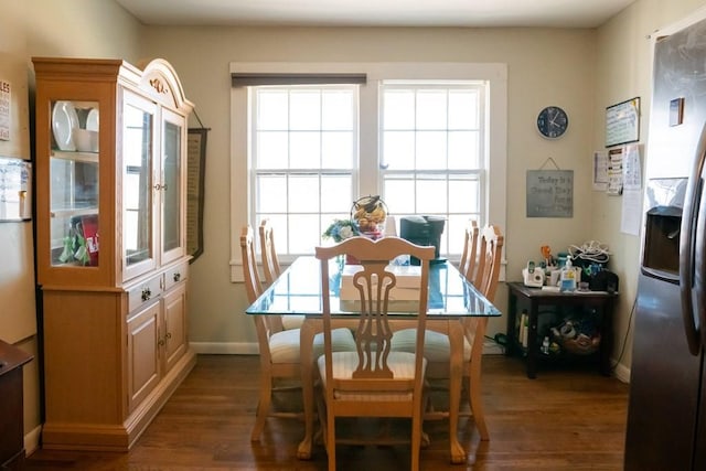 dining room featuring plenty of natural light, baseboards, and wood finished floors