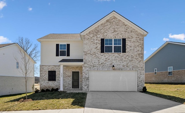 traditional-style home featuring a garage, driveway, brick siding, and a front yard