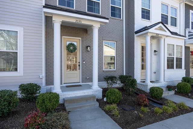 entrance to property with brick siding