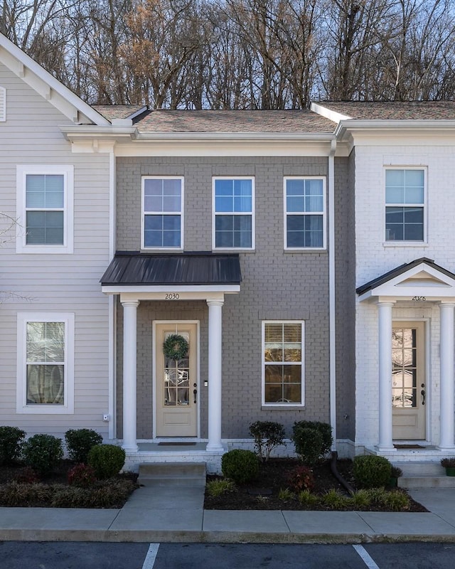 townhome / multi-family property with brick siding