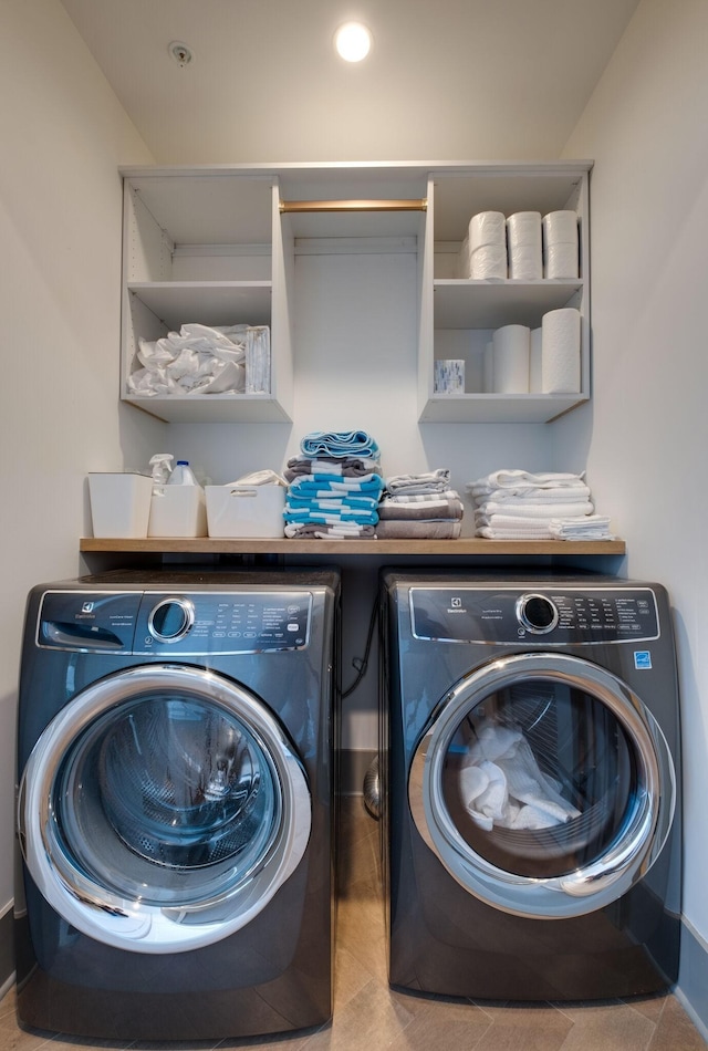 washroom featuring laundry area, independent washer and dryer, and tile patterned floors