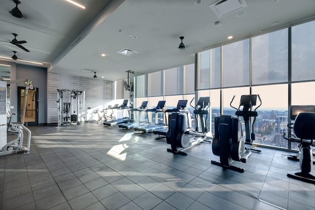 workout area with visible vents, a wall of windows, and a ceiling fan