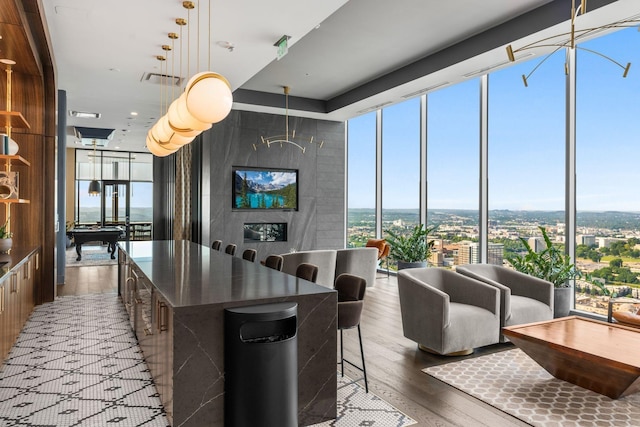 kitchen featuring a spacious island, expansive windows, a wealth of natural light, and hardwood / wood-style floors