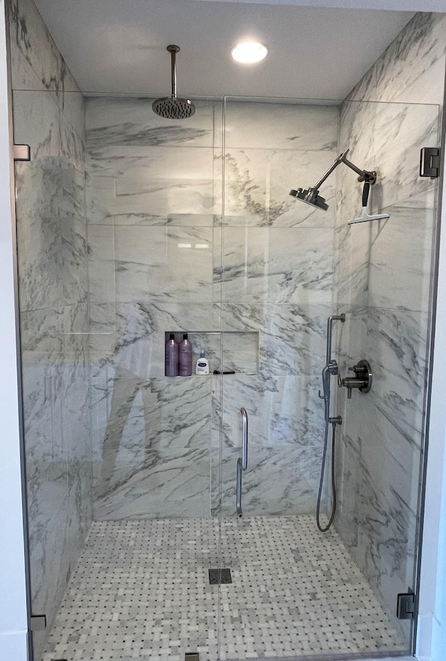 bathroom with a marble finish shower