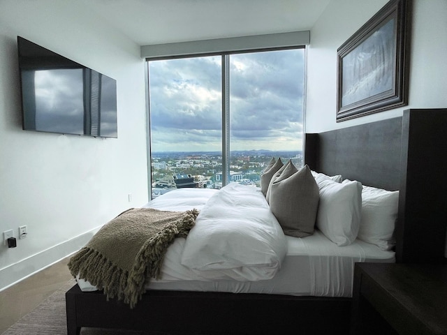 bedroom featuring wood finished floors and baseboards