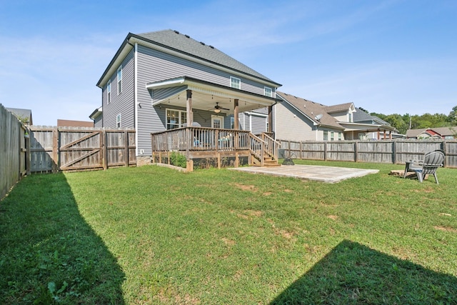 back of house featuring a ceiling fan, a fenced backyard, and a lawn