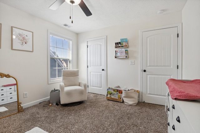 recreation room with carpet, visible vents, a ceiling fan, a textured ceiling, and baseboards