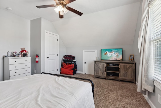 carpeted bedroom with lofted ceiling, ceiling fan, and baseboards