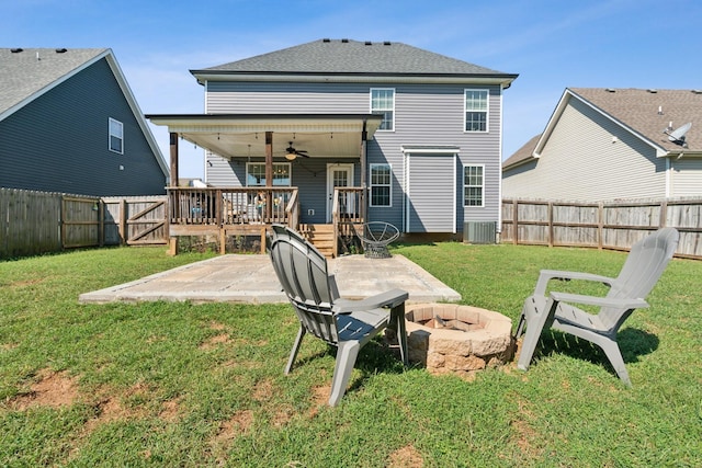 rear view of house with a ceiling fan, a patio area, a lawn, and a fenced backyard