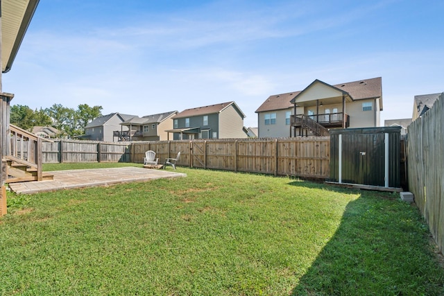 view of yard featuring a residential view, a patio area, and a fenced backyard