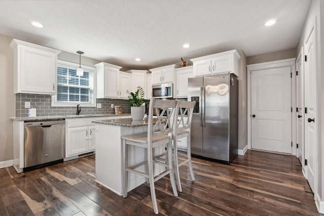 kitchen with white cabinetry, appliances with stainless steel finishes, and dark wood finished floors