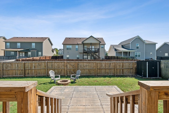 view of yard with a residential view, a fire pit, and fence