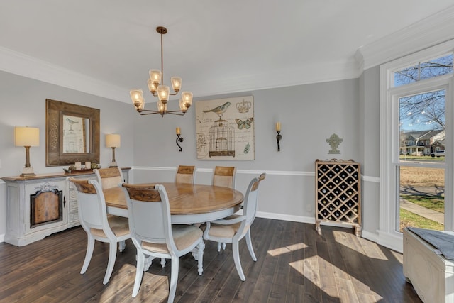 dining area with dark wood-type flooring, a notable chandelier, crown molding, and baseboards