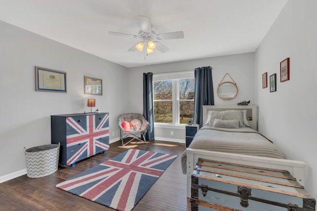 bedroom featuring ceiling fan, baseboards, and wood finished floors