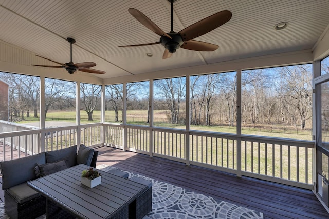 wooden deck featuring an outdoor living space and a ceiling fan