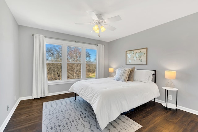 bedroom with wood finished floors, a ceiling fan, and baseboards