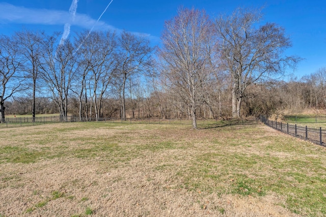 view of yard with a rural view and fence