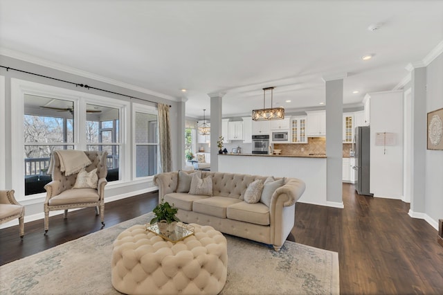 living area featuring baseboards, ornamental molding, dark wood finished floors, and recessed lighting