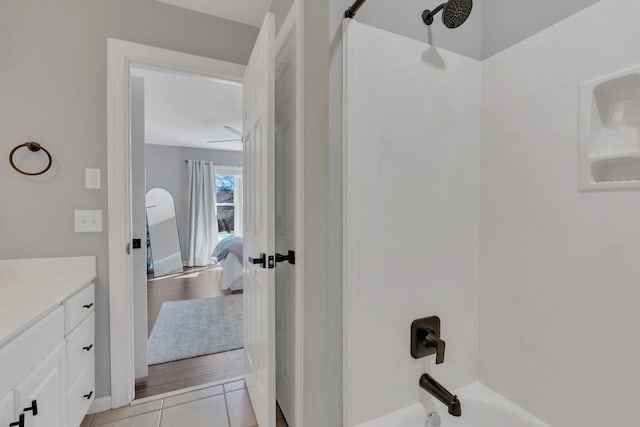 bathroom featuring washtub / shower combination, wood finished floors, and vanity