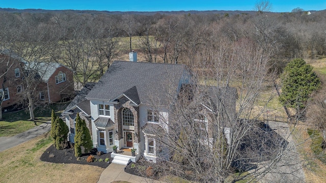 drone / aerial view with a wooded view