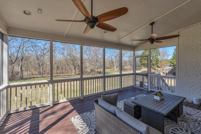 unfurnished sunroom with a ceiling fan