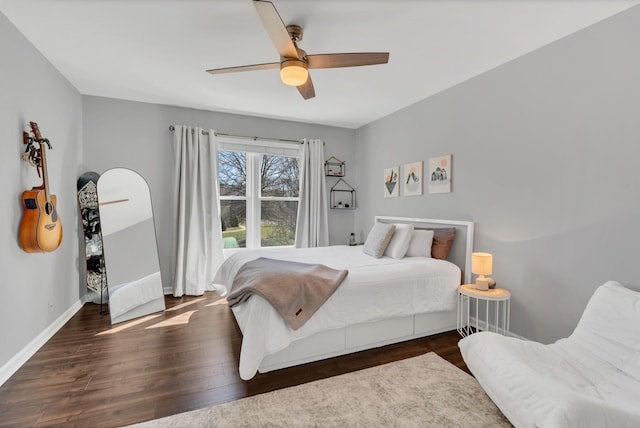 bedroom featuring ceiling fan, baseboards, and wood finished floors