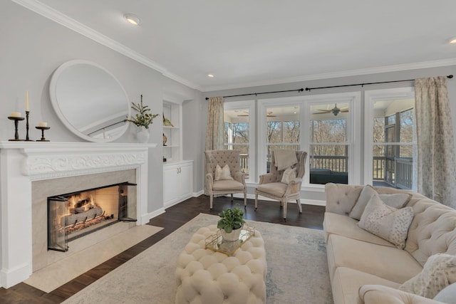 living area with a healthy amount of sunlight, a fireplace, and wood finished floors