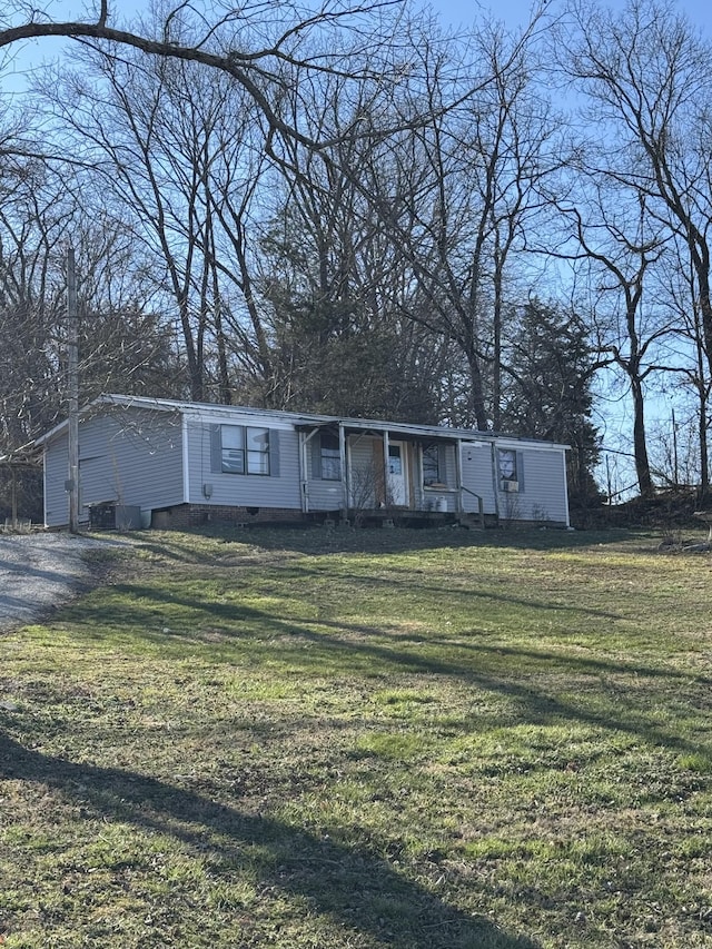 view of front of house with crawl space, central AC, and a front yard