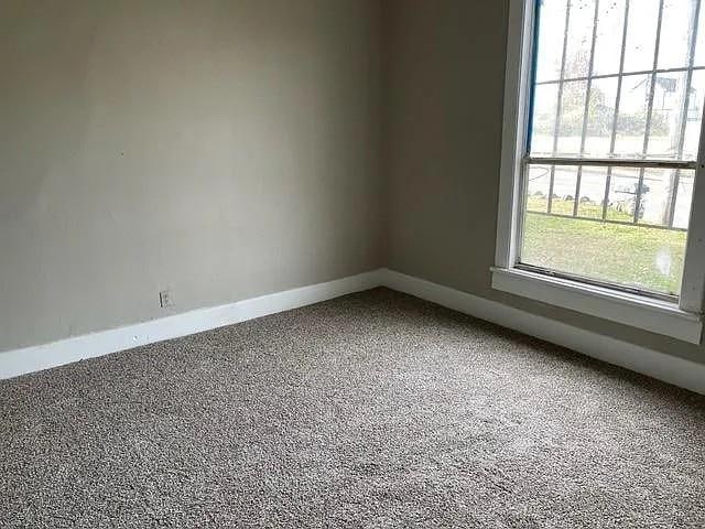 spare room with baseboards