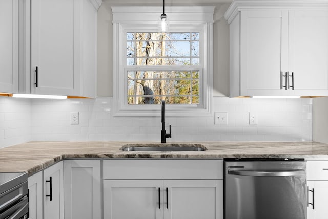 kitchen featuring stainless steel appliances, white cabinets, a sink, and decorative backsplash