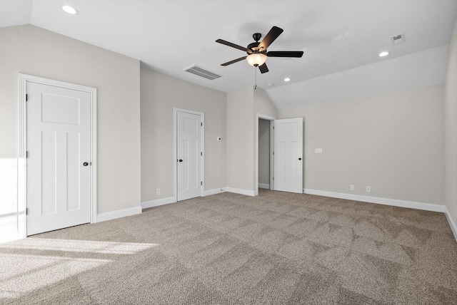 unfurnished bedroom with carpet floors, visible vents, and vaulted ceiling