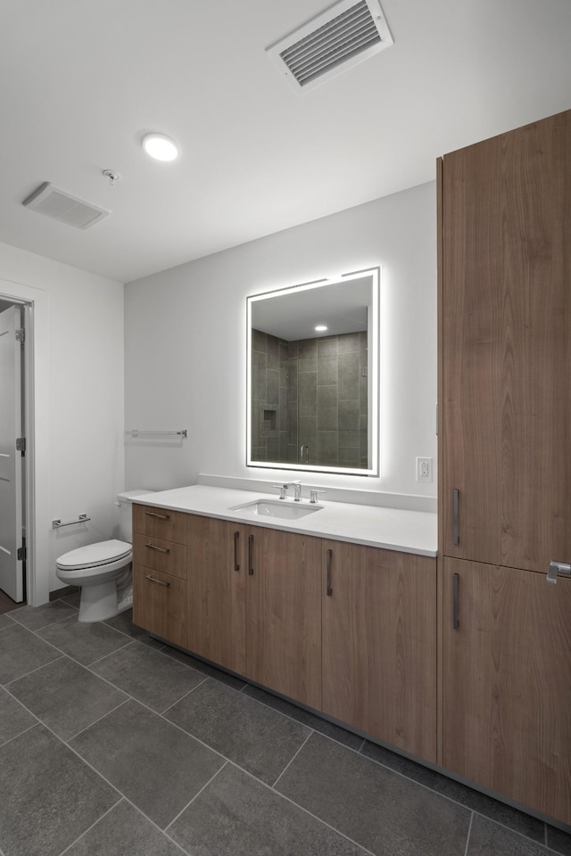 bathroom featuring tile patterned floors, visible vents, toilet, and vanity